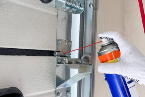 How should I lubricate my garage door